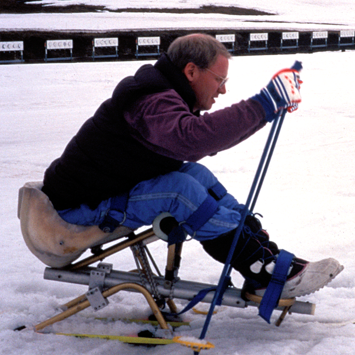ski tips down while reaching forward with poles