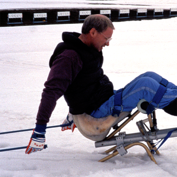 poles are pulled through, causing the ski spring to snap back into a rear-tilted position