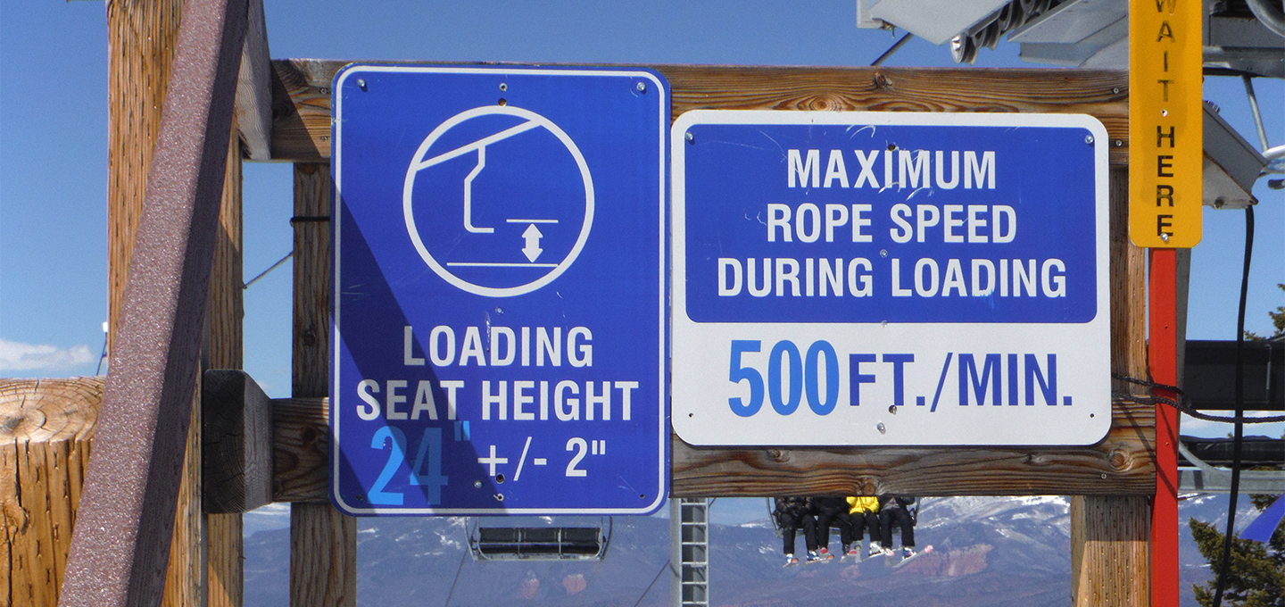 Ski lift signage indicating loading seat height and loading speed